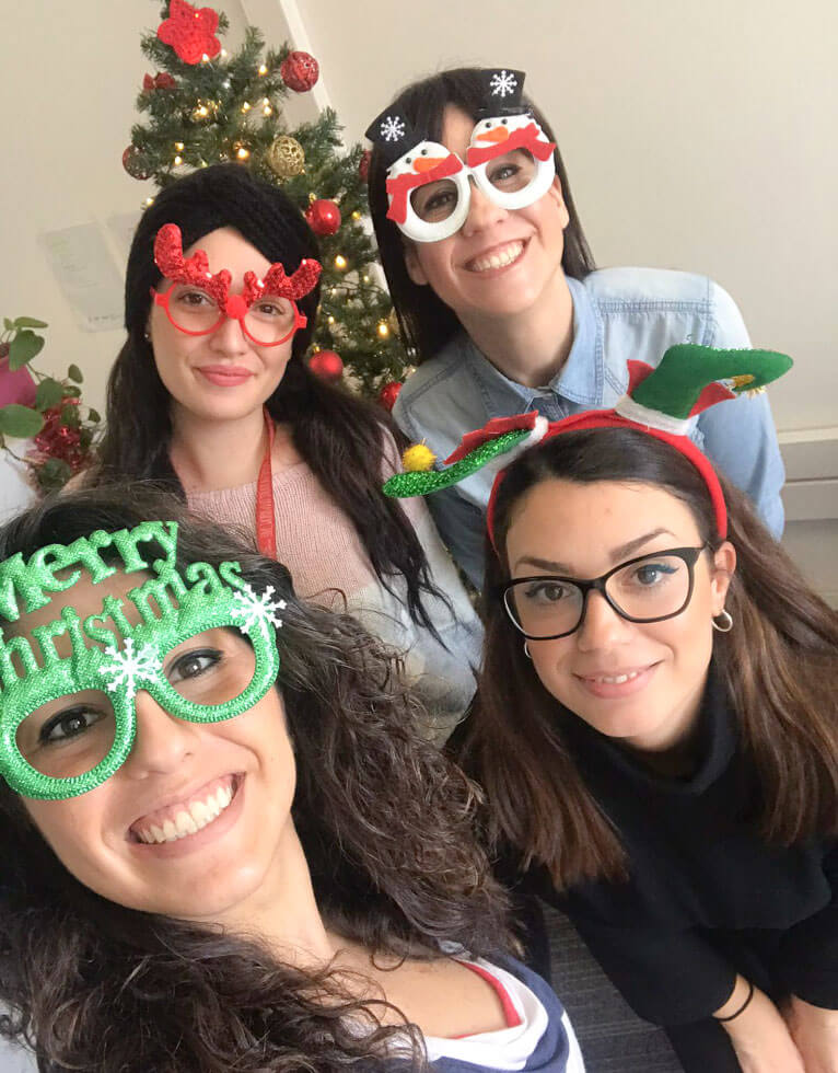 four women smiling christmas costume